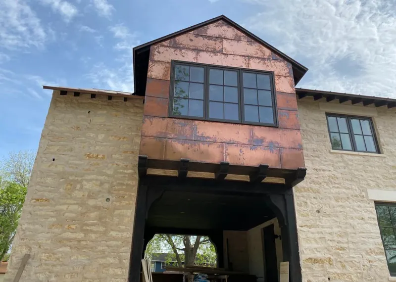 Copper metal panel facade on a stone building for Metal Roof Coating in Ardmore